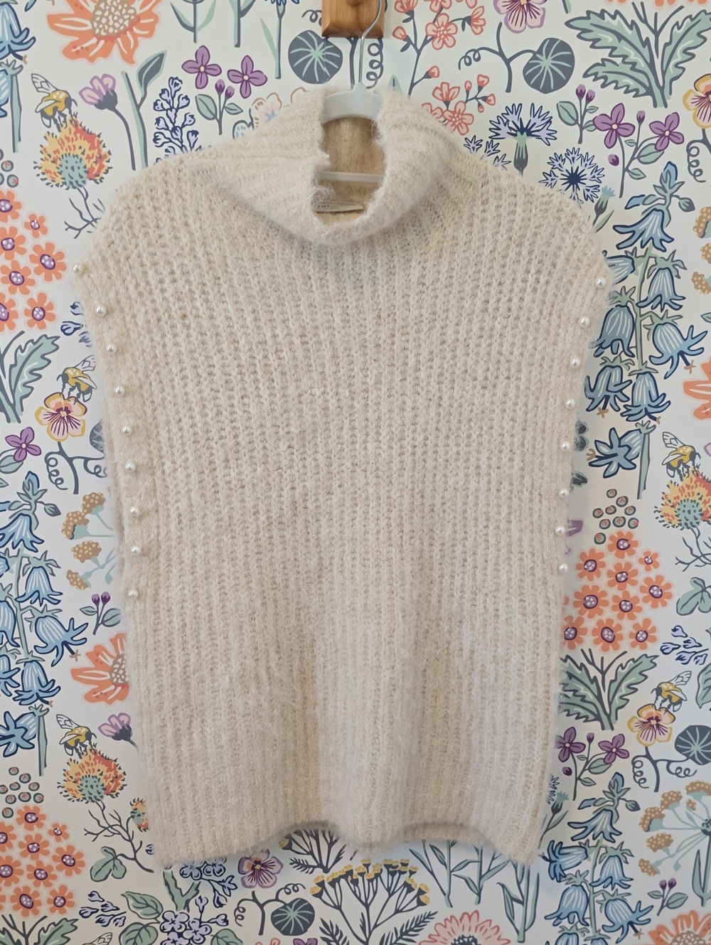 Sleeveless Cream Turtleneck Sweater with Pearl Trim